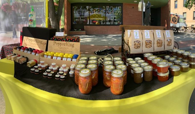 The PepperKing market table: jars of salsa, bottles of hot sauce and bags of spicy snacks